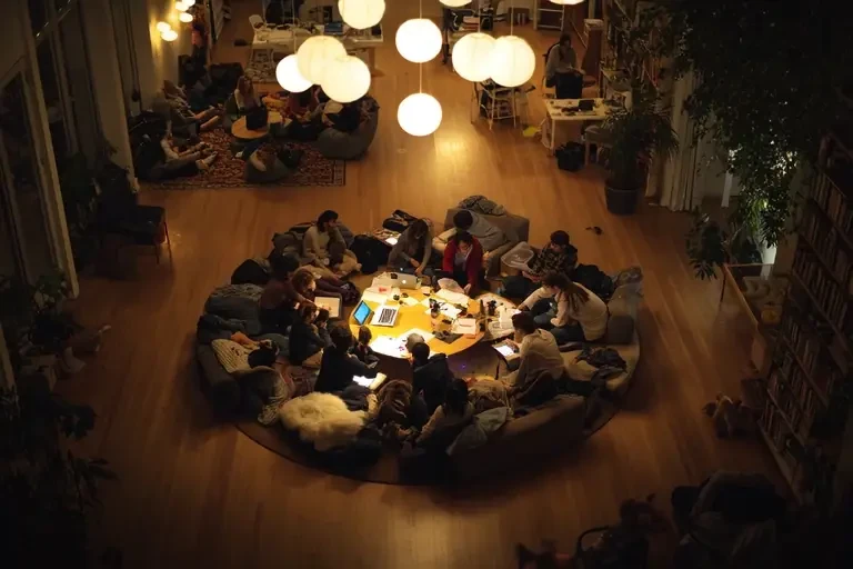 A circle of people working together late into the night